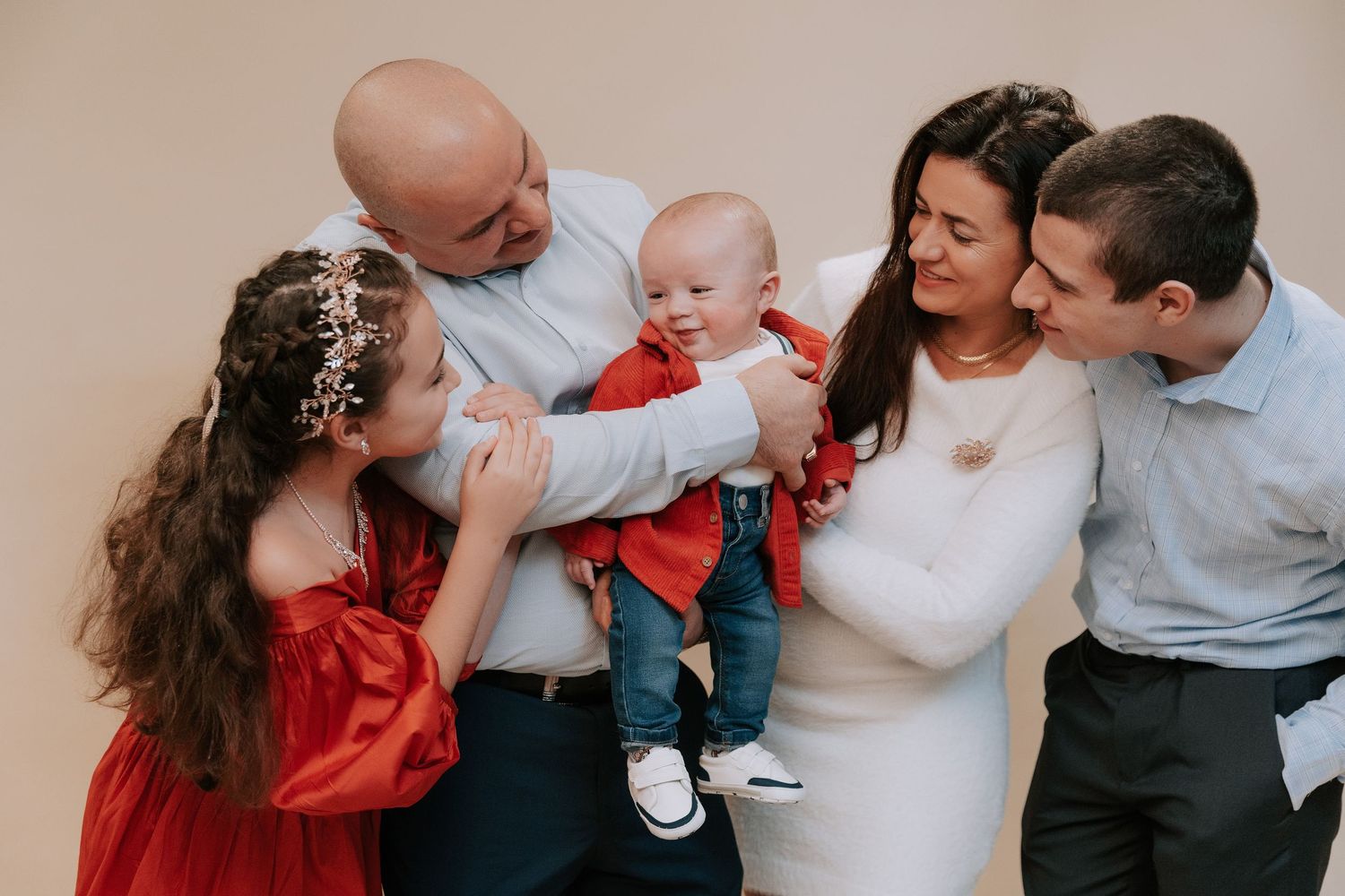 A series of candid family photos showing tender moments and interactions in warm neutral tones.