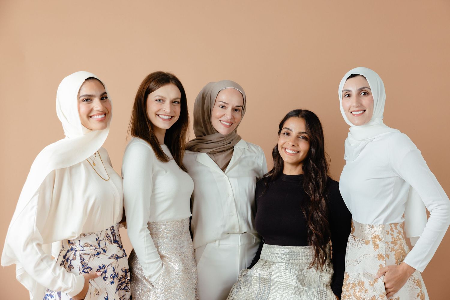 A collection of fashion photos showing someone in a white robe and beige hijab posing against a neutral background.