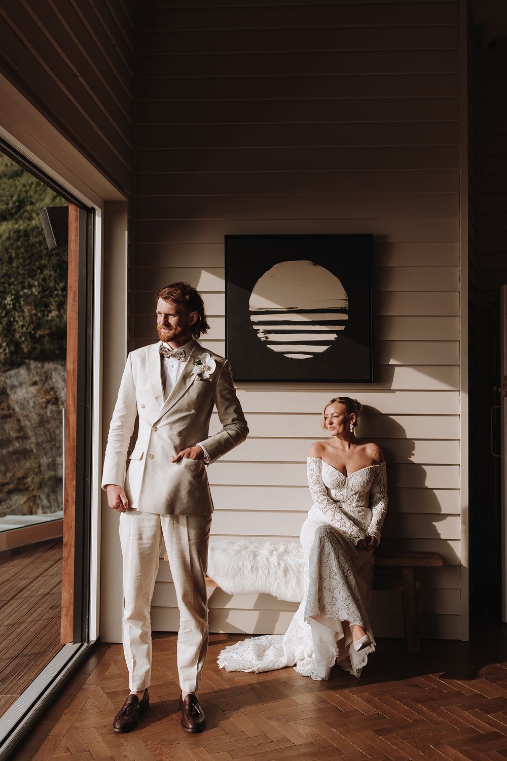 A collection of artistic wedding photos showing couples in light and shadow against wooden walls and windows.