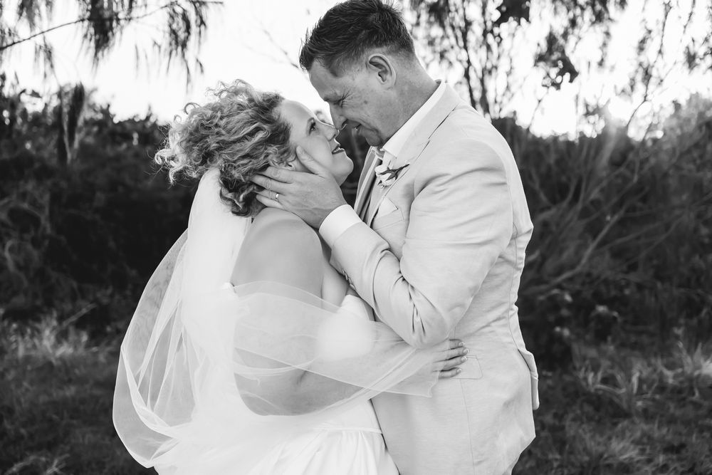 A romantic black and white wedding photo collage shows intimate moments between a couple in an outdoor setting.