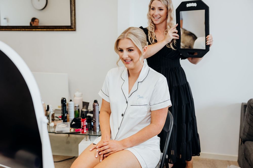 Getting ready scene in a bright white room with wedding day preparations.