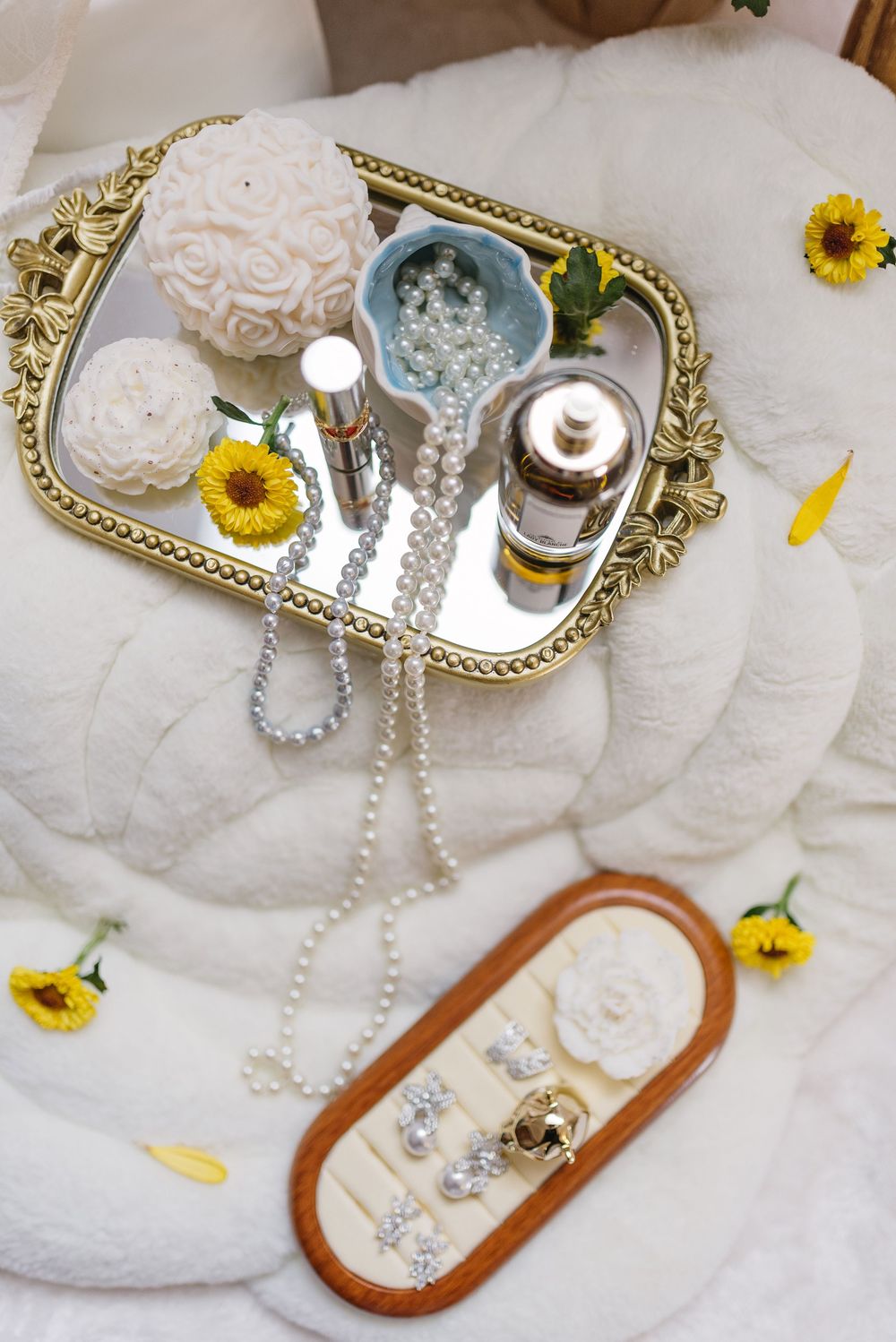 Vintage-style vanity tray with pearls, sunflowers and delicate accessories.