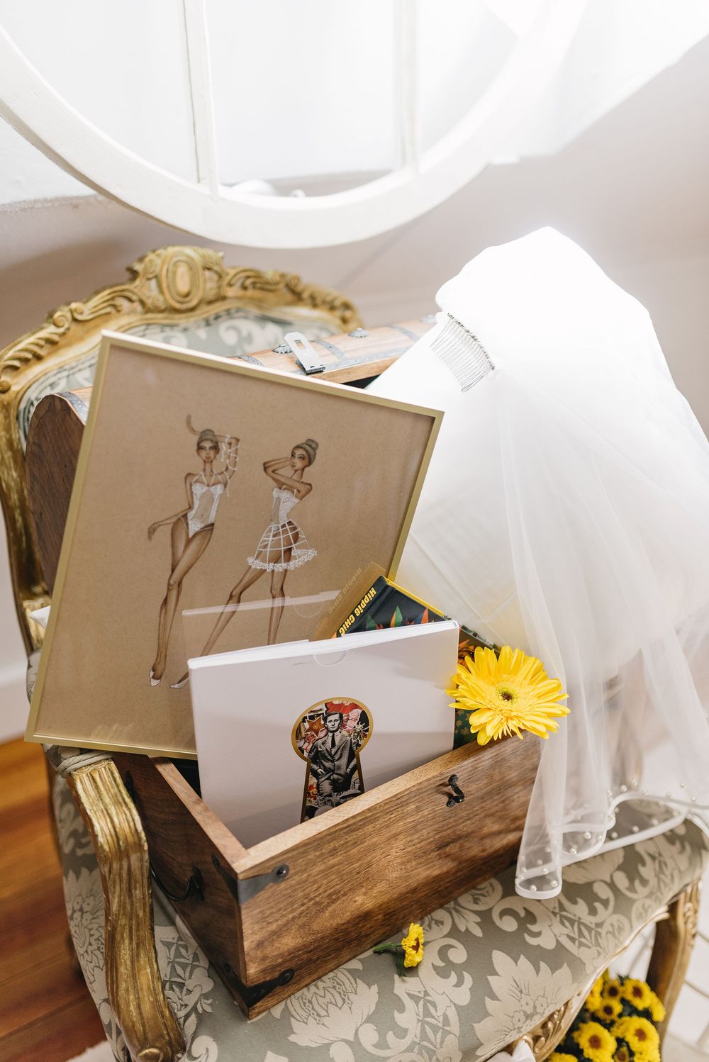 Rustic wedding decor featuring wooden displays, fashion sketches and yellow sunflowers.