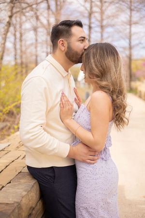 A romantic couple shares tender moments in a sequence of four outdoor photos against a natural backdrop.