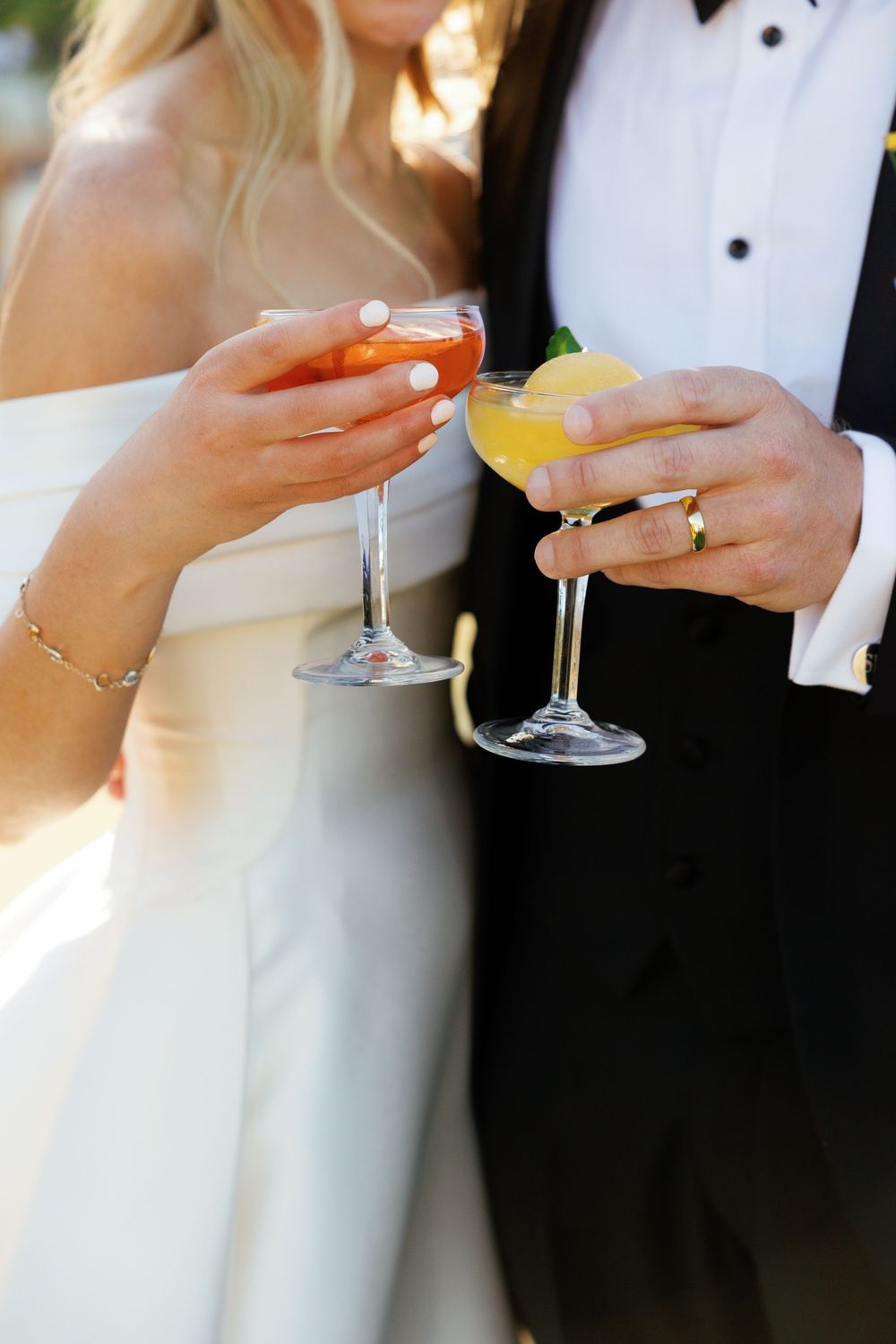 Wedding guests holding champagne glasses in formal attire during an elegant celebration toast.