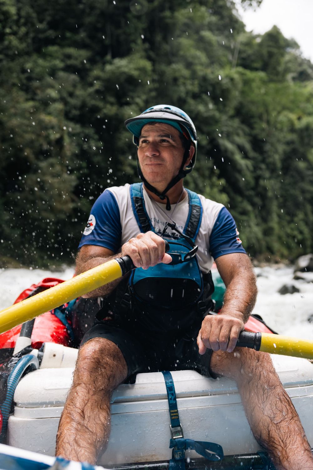 Close-up view of rafting equipment and safety gear during whitewater adventure on river.