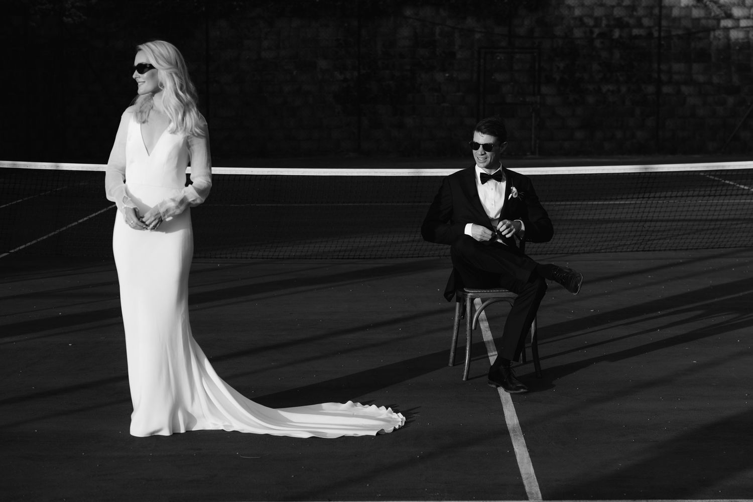 Black and white wedding photos showing romantic moments between newlyweds in an outdoor setting.