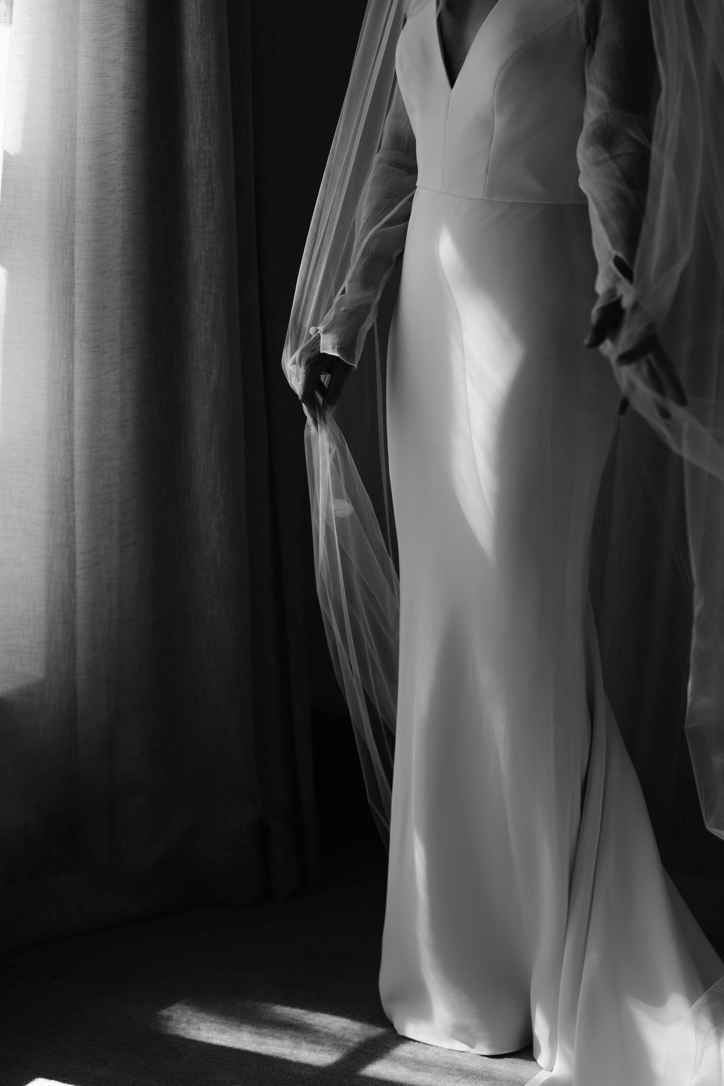 Black and white artistic photo series showing flowing white fabric against dark background creating dramatic contrast.