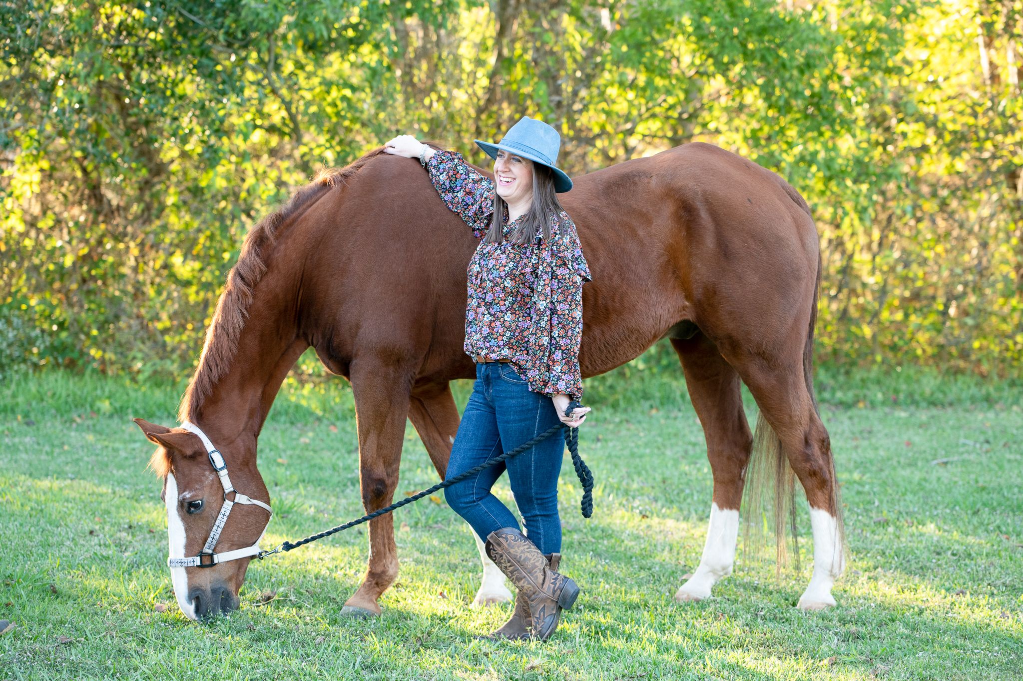 Owner’s hand resting on horse’s neck, capturing the quiet trust between them.
