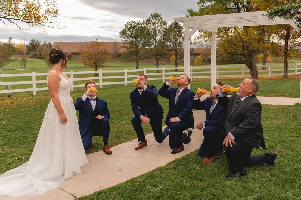 Wedding celebration on a scenic farm property with white fencing and autumn colors in the landscape.