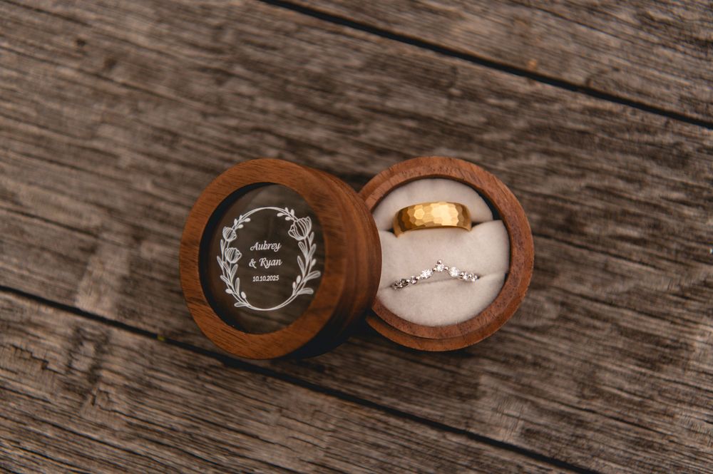 Wooden ring box with rustic texture shown from multiple angles on weathered wood surface.
