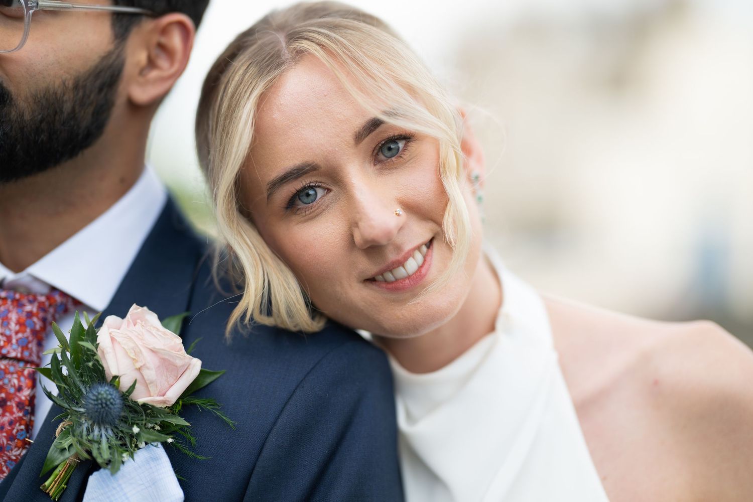 Romantic couple sharing tender moment during wedding portraits.