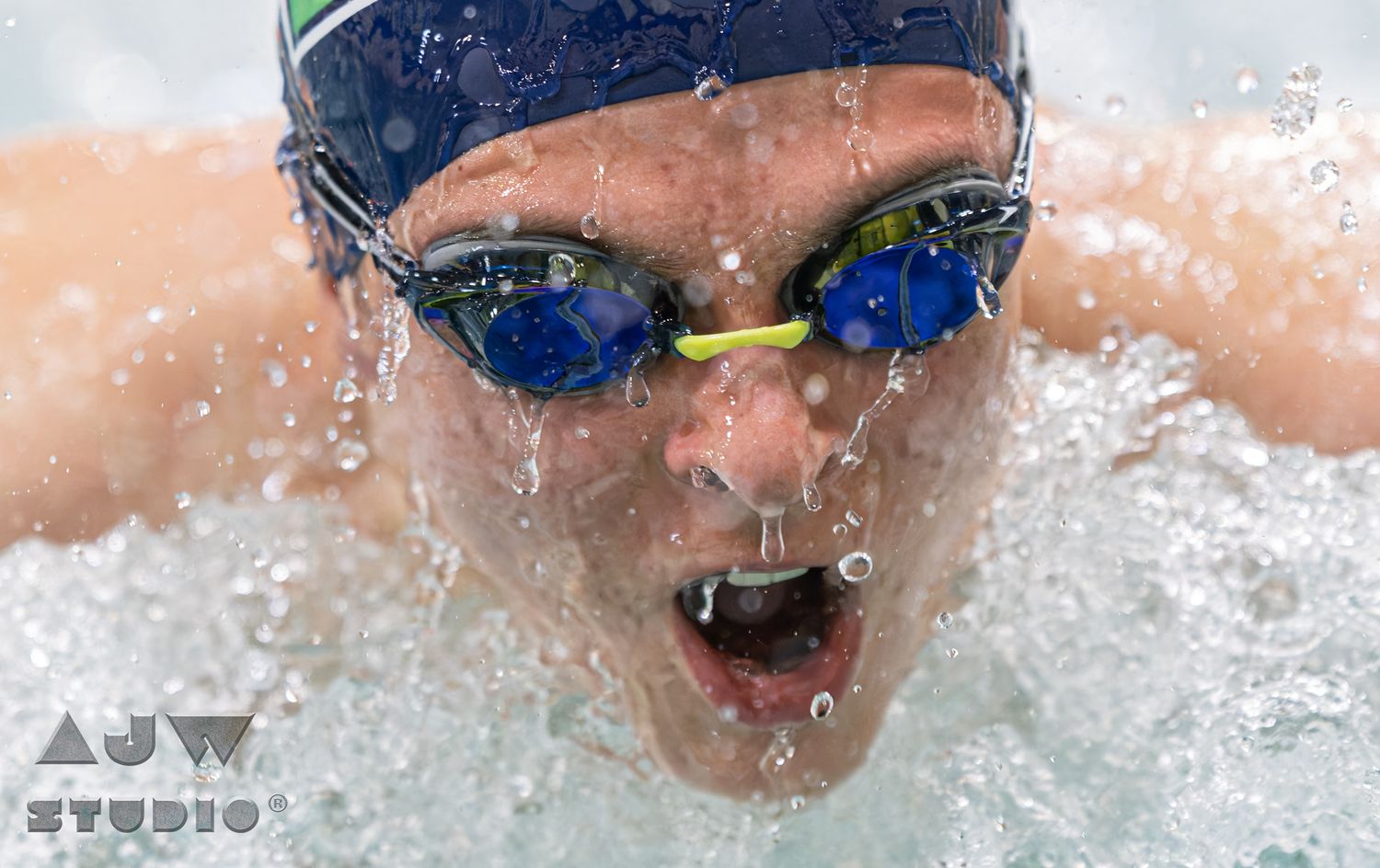 A swimmer glides through crystal clear water during a competitive swimming race.