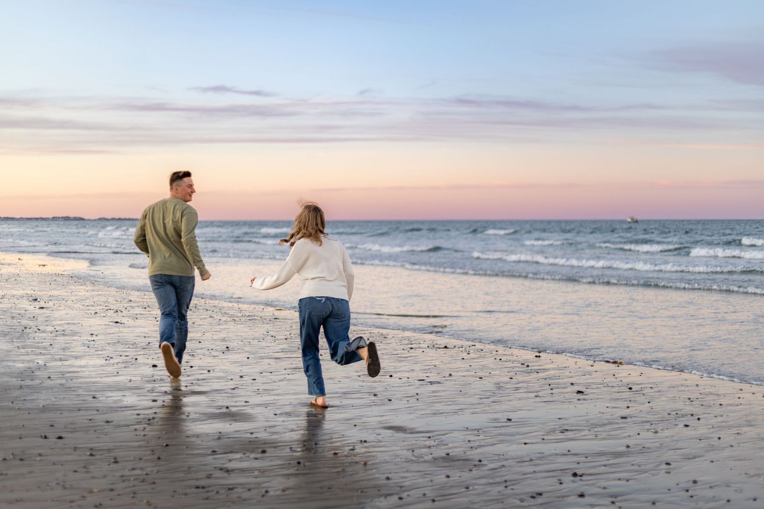 A romantic engagement photo session in a golden marsh field during sunset.
