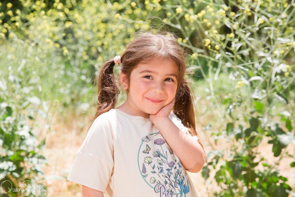 A series of four outdoor portraits showing someone with long brown hair against a sunny natural backdrop.