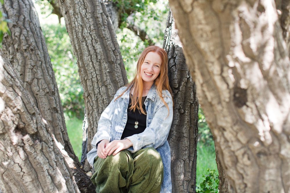 A collection of outdoor portraits taken against tree trunks in a natural wooded setting.