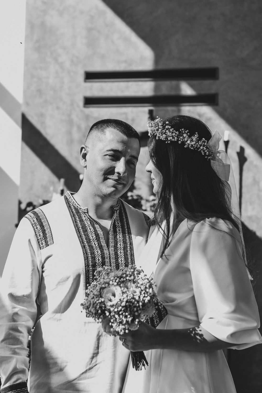 A romantic black and white photo sequence showing a couple in traditional wedding attire sharing intimate moments together.