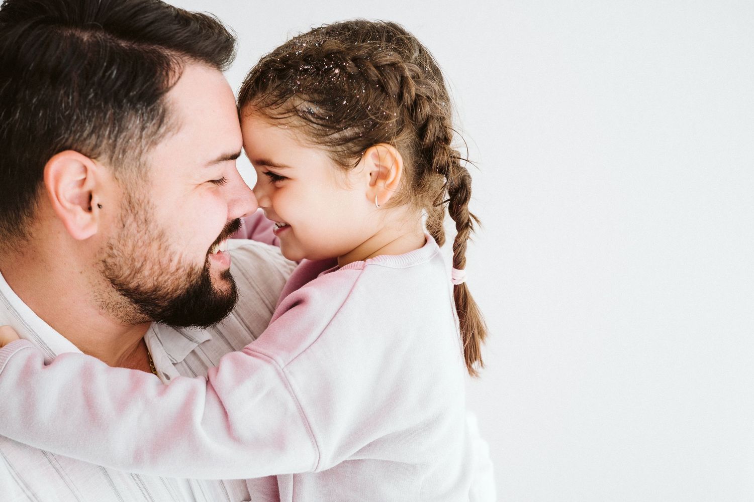 Tender family moments captured against white background.