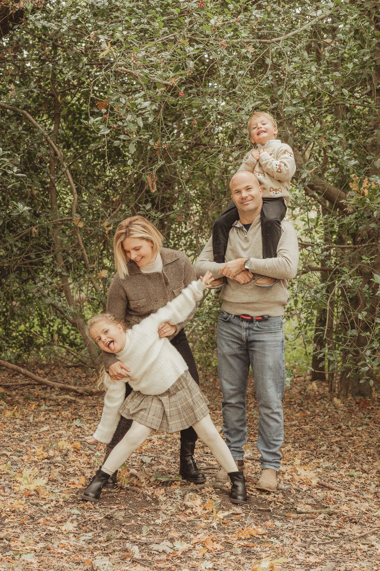 Playful sequence of figures in casual attire dancing and posing together among autumn leaves and trees in a forest setting.