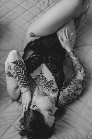 Close-up black and white images showing ornate floral and botanical henna designs on hands and arms against a light background.
