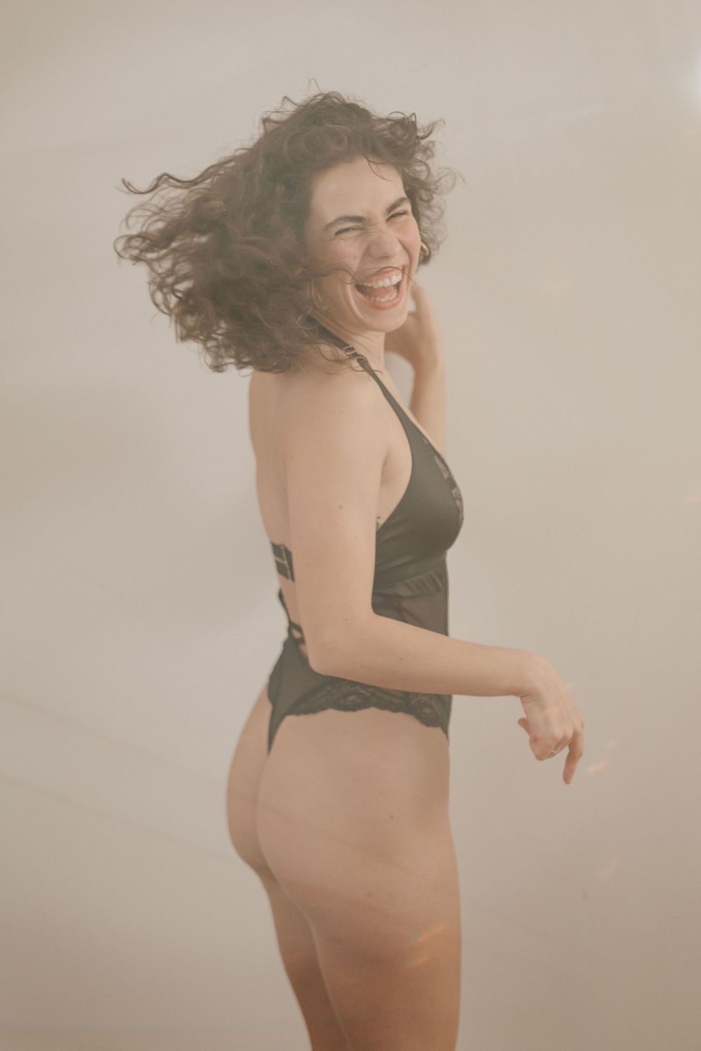 A sequence of dance movement shots showing a figure in a black dress against a light background expressing fluid motion.