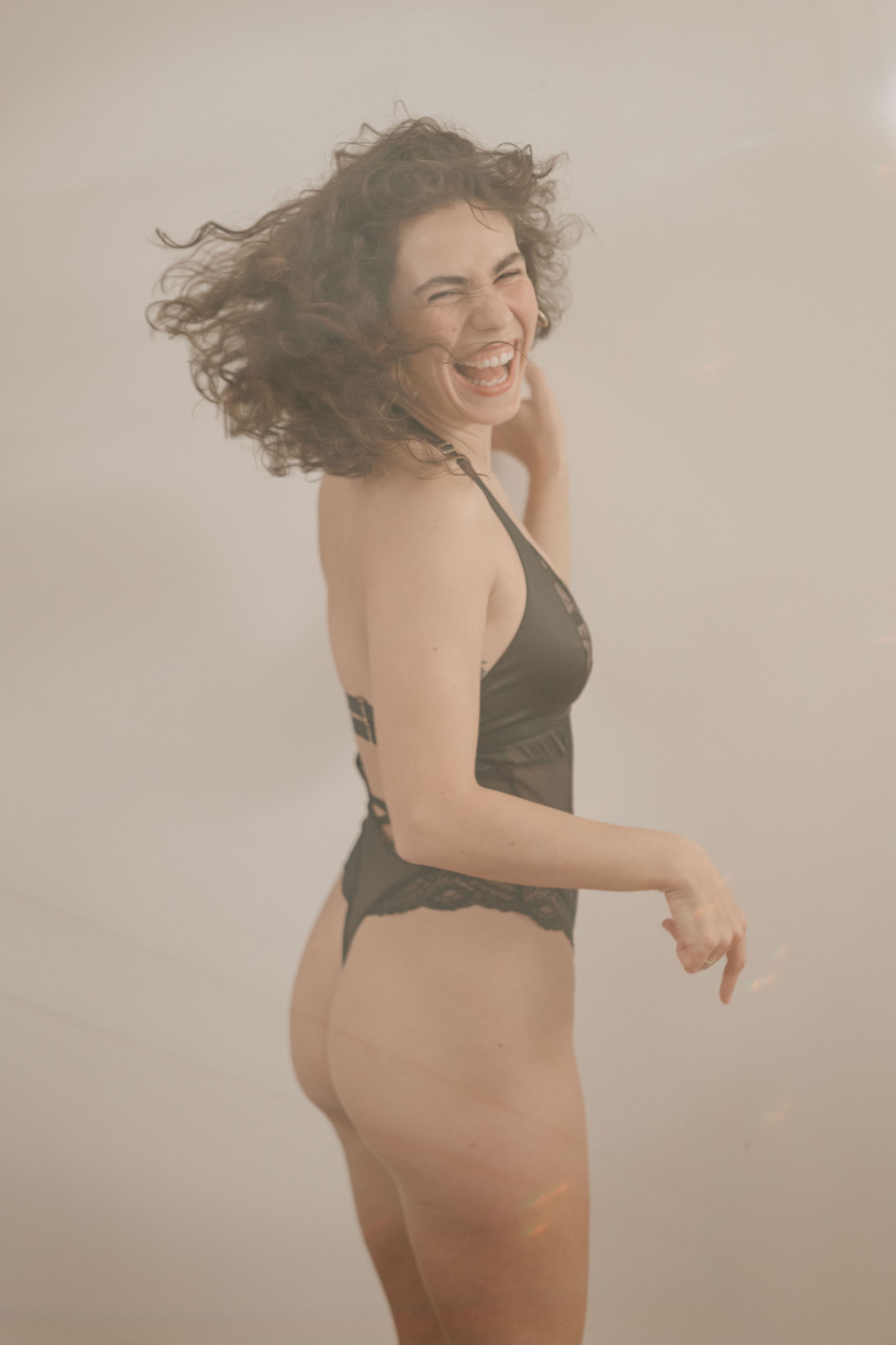 A sequence of dance movement shots showing a figure in a black dress against a light background expressing fluid motion.