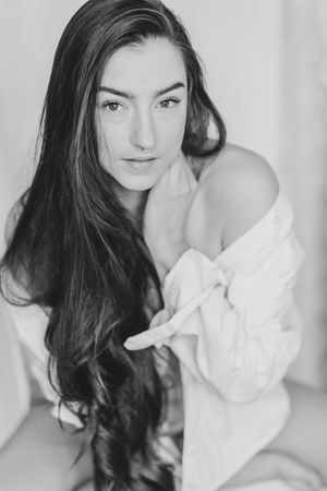 Black and white portrait series showing a woman with flowing dark hair wearing a white button-down shirt against a light background.
