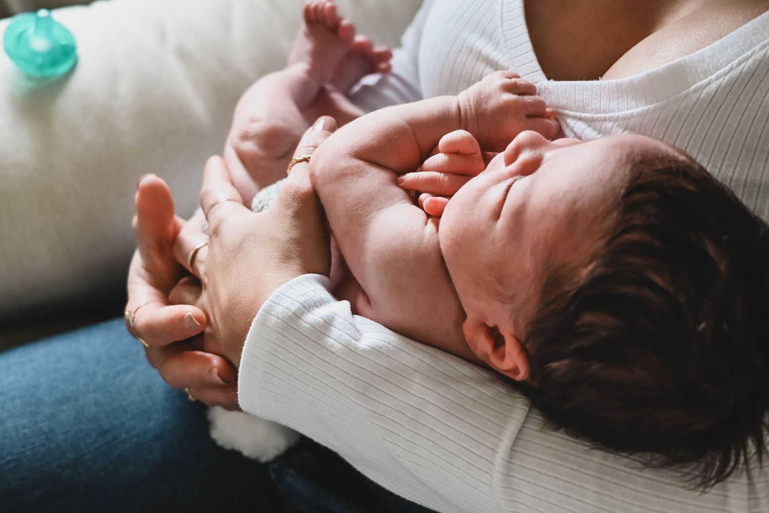 Mom holding baby boy during her newborn session with K. Manchuck Photography
