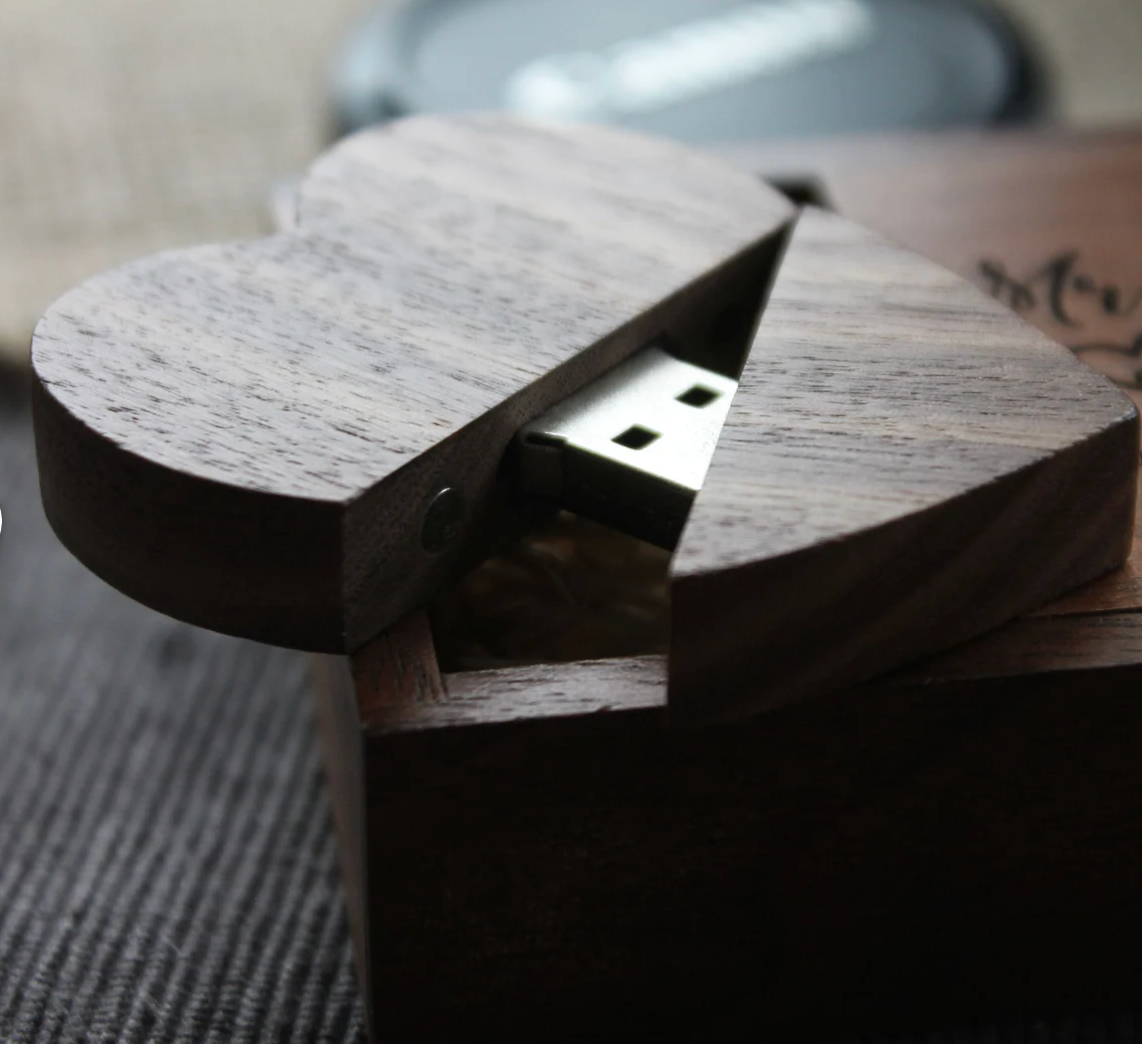 Wooden heart-shaped USB drive case with hidden compartment for digital storage.