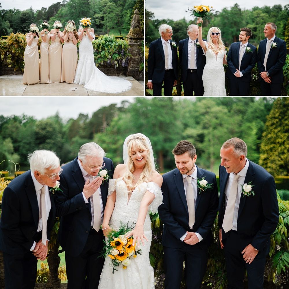 Wedding party poses outdoors, bride in white gown with bridesmaids, groomsmen, and family amid lush greenery.