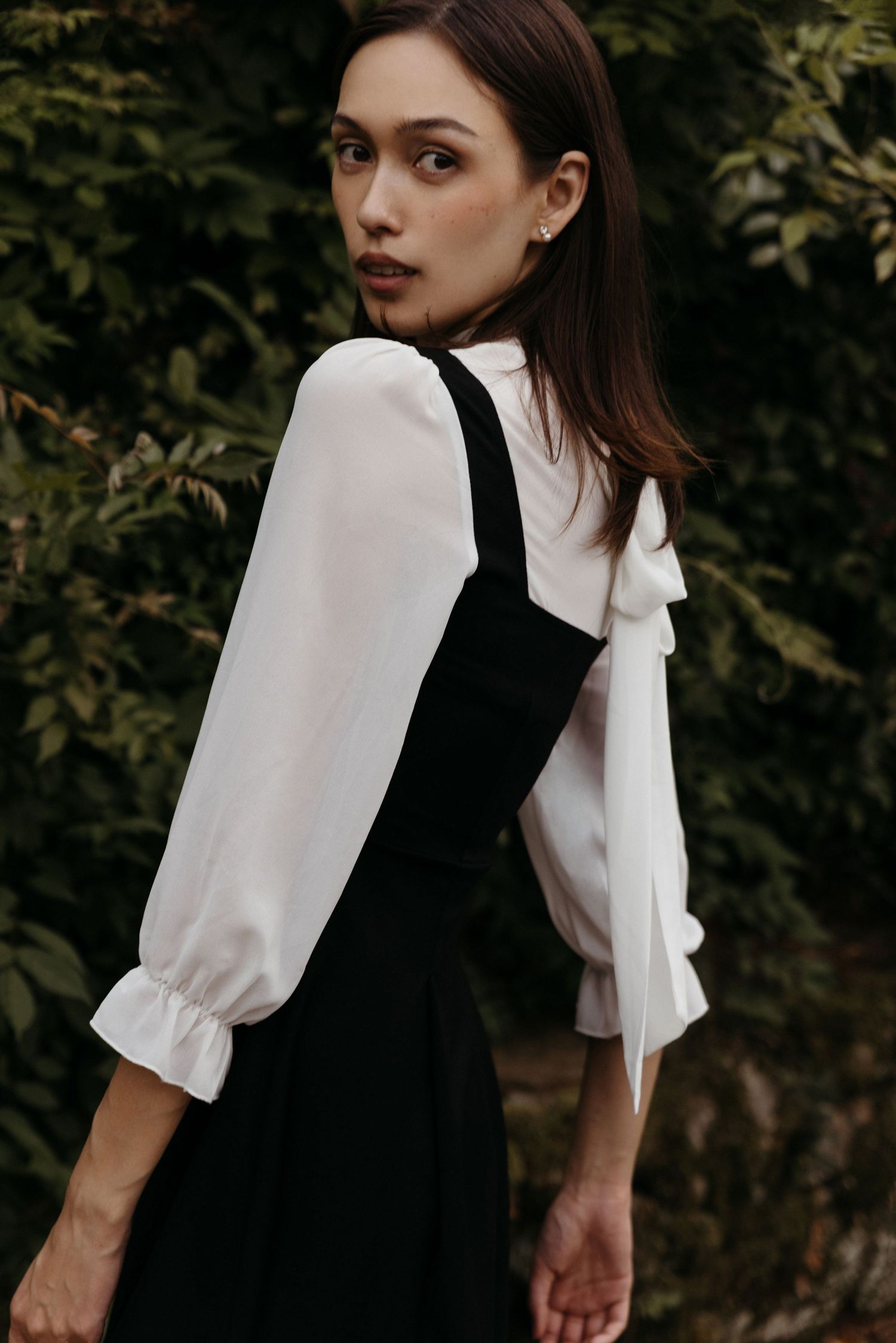 Eurasian editorial model wears black and white pinafore dress, Historic Downtown Atlanta fashion photography