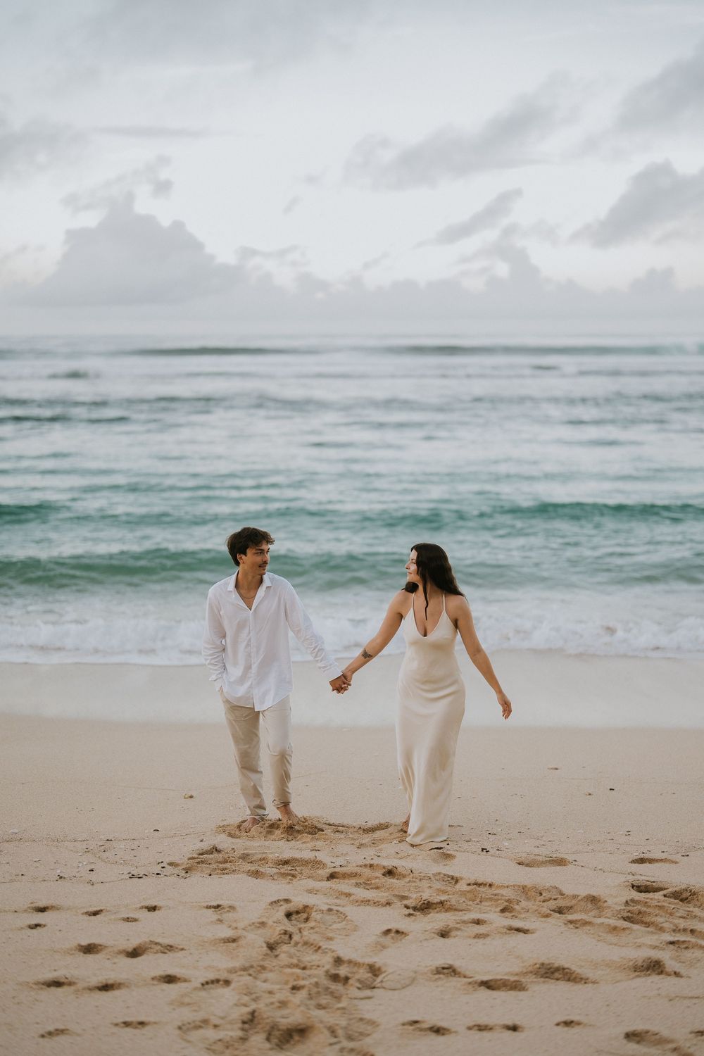 Romantic engagement couple photoshoot at Melasti Beach, Bali.