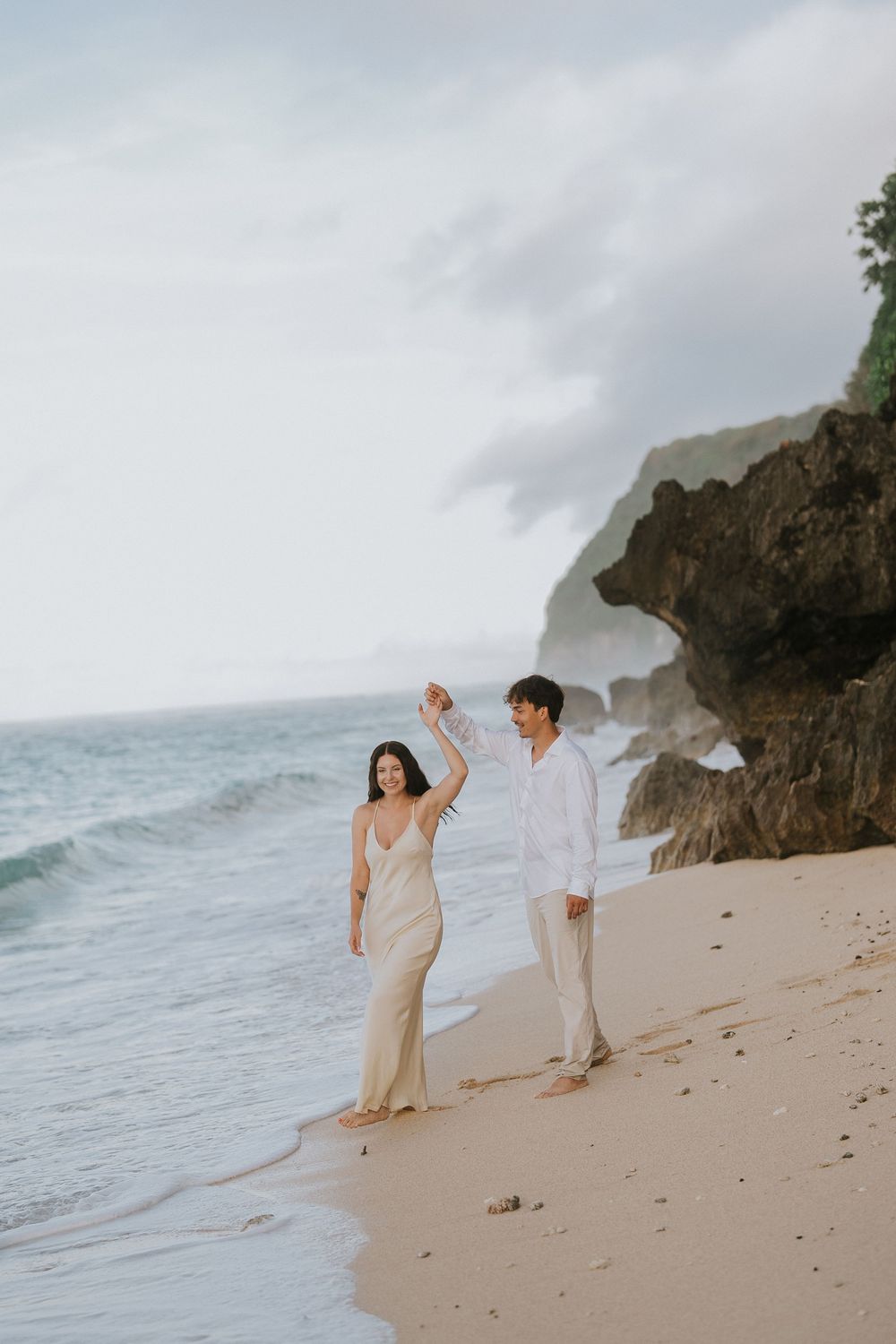 Romantic engagement couple photoshoot at Melasti Beach, Bali.