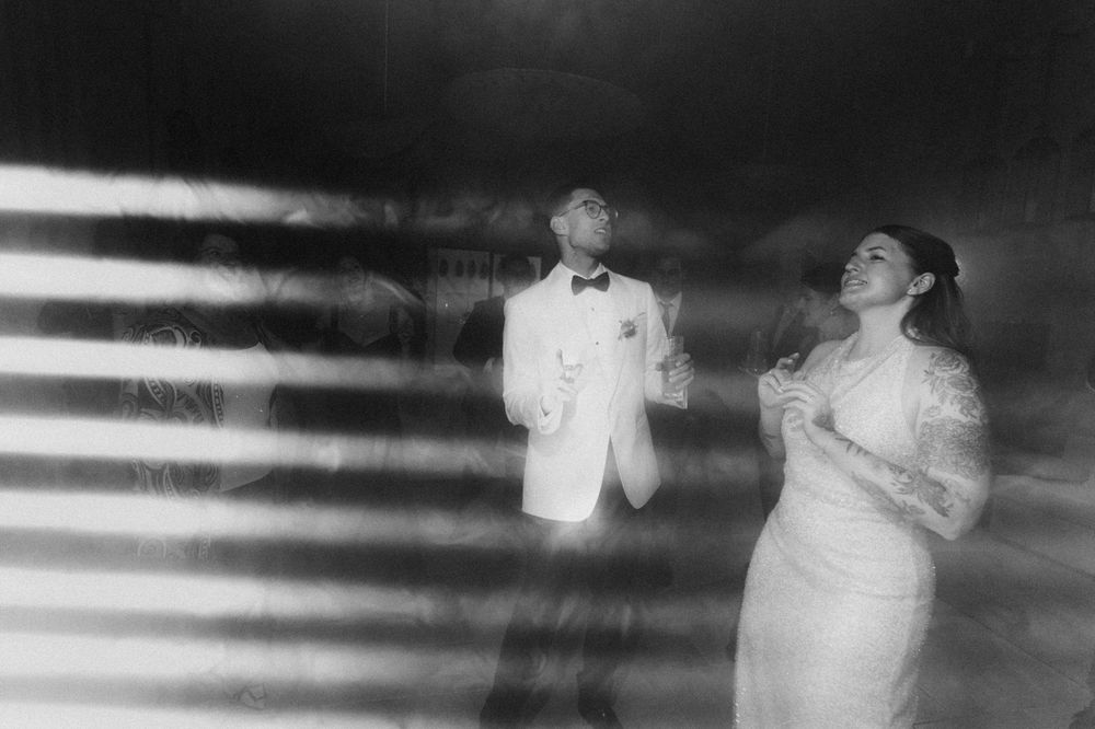 Bride and groom dancing elegantly in a dreamy black and white wedding photo.