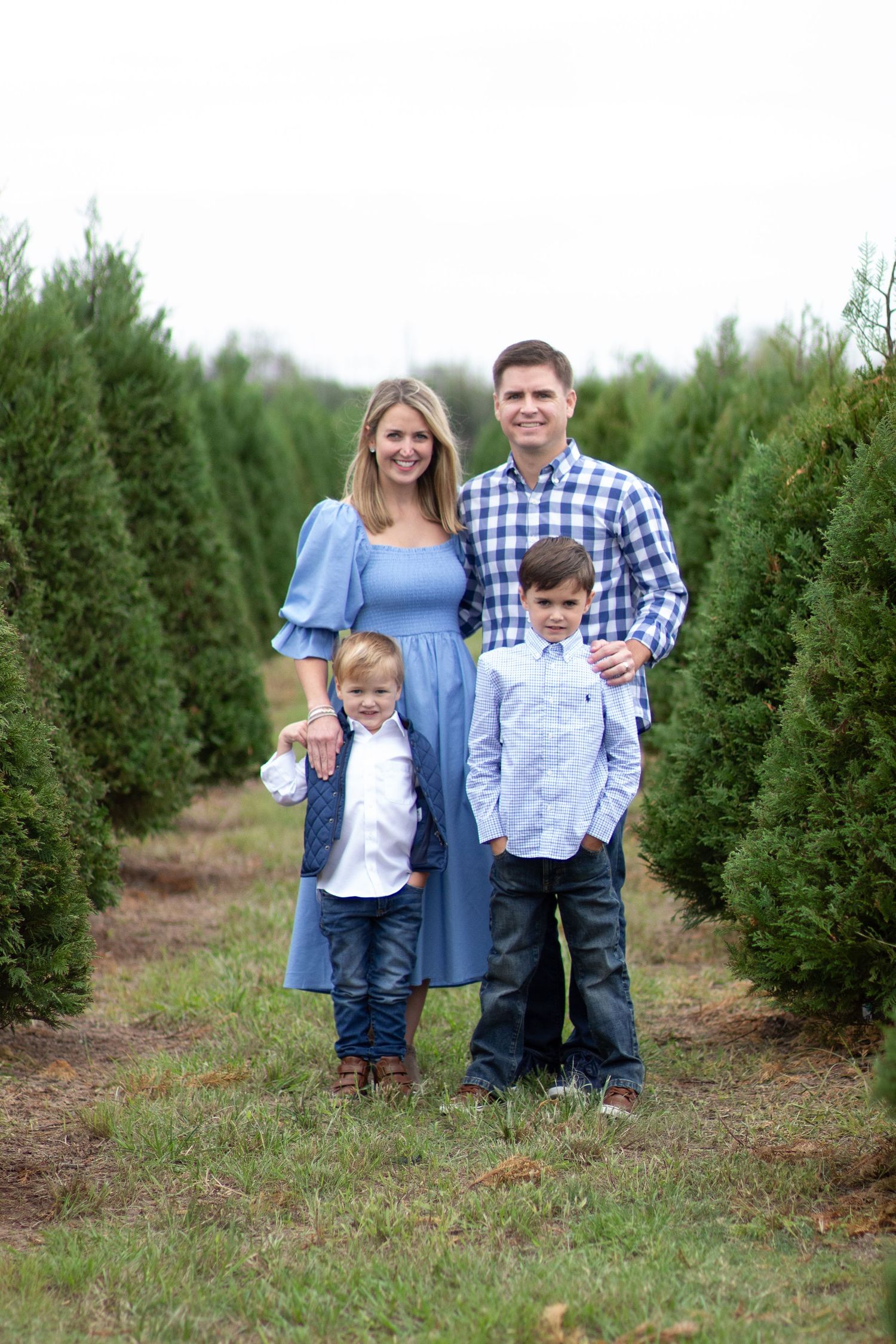 Family of four at a Christmas tree farm during a holiday photography session in Houston
