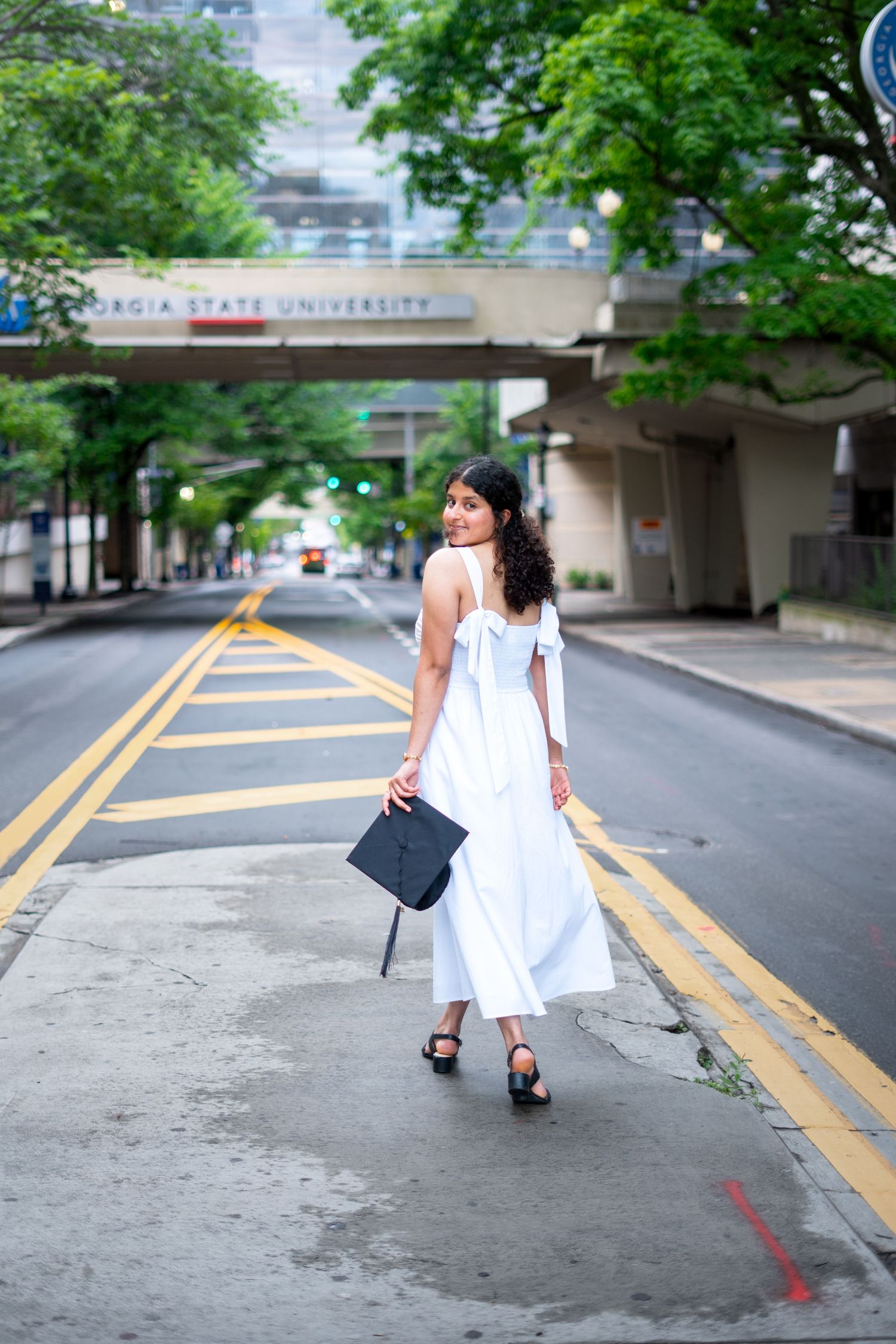 Georgia State graduation photos in front of the iconic library bridge with GSU branding, one of the best spots on the Atlanta campus