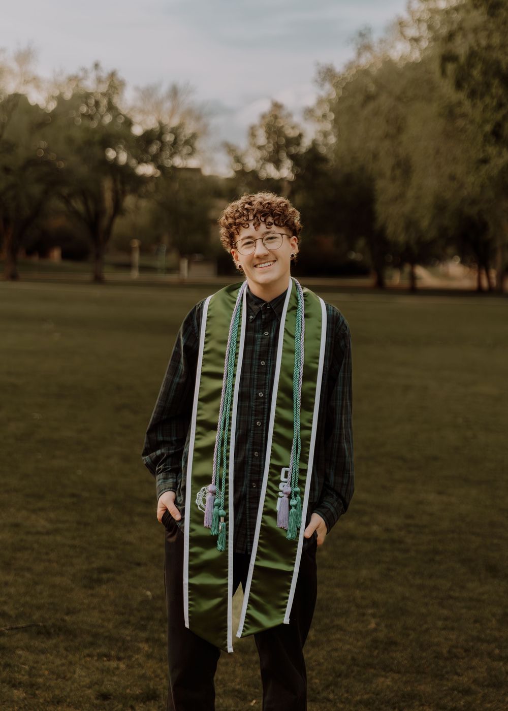 Boy stands and poses for graduation photos at CSU (Colorado State University) graduation photos in Fort Collins, Colorado