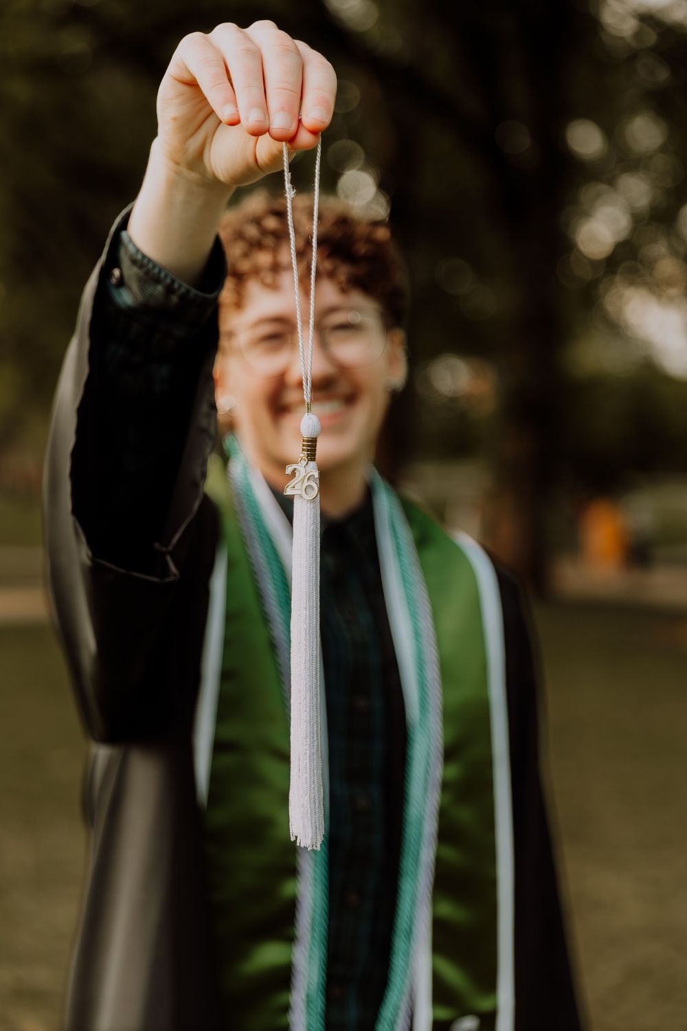 Boy stands and poses for graduation photos at CSU (Colorado State University) graduation photos in Fort Collins, Colorado