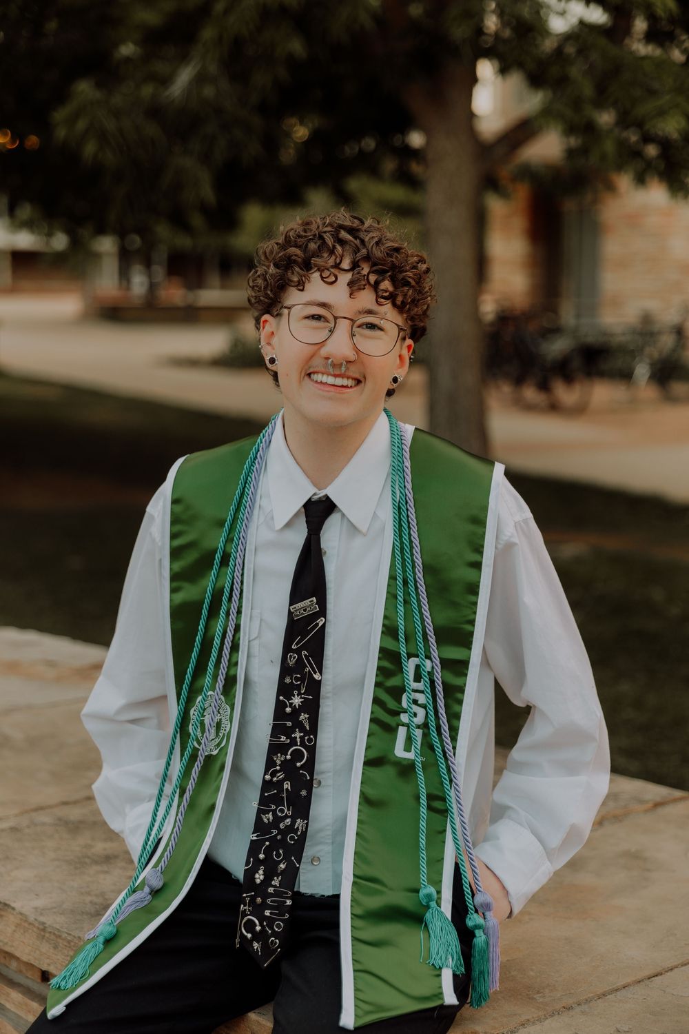 Boy sits and poses for graduation photos at CSU (Colorado State University) graduation photos in Fort Collins, Colorado