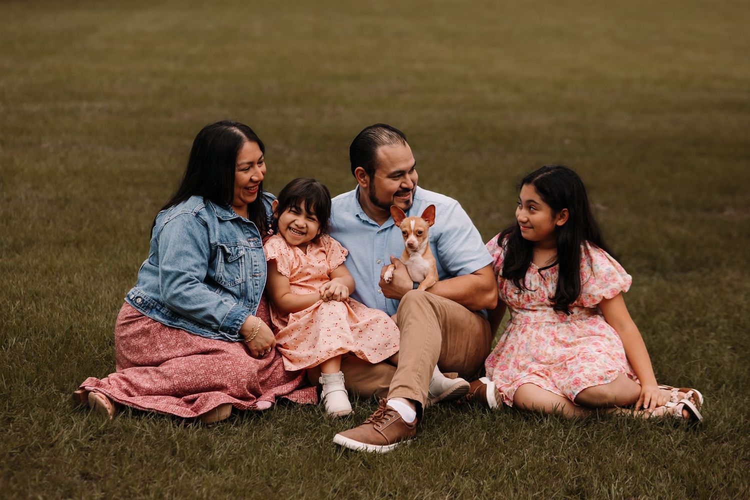 Family laughing together during an outdoor session in Houston, Texas. Warm and cozy family photography capturing genuine connections & love.