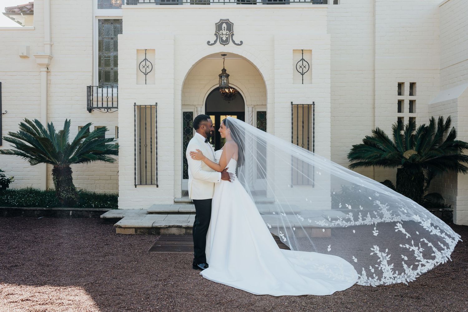 Wedding guests toss colorful confetti in celebration during an outdoor ceremony.