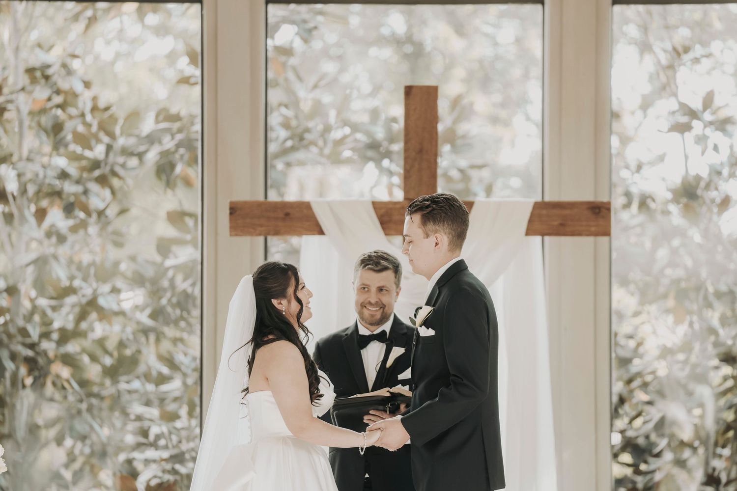 Elegant black tie wedding ceremony featuring white florals