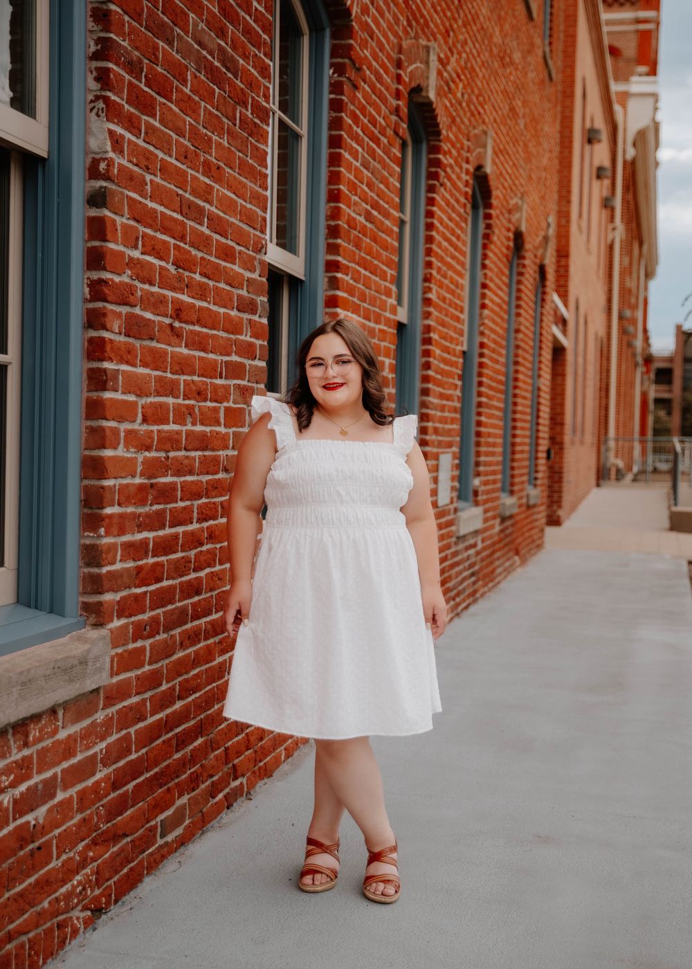 Girl stands and poses for senior photos, cinematic, urban, and portrait photos in Denver, Colorado outside and in nature