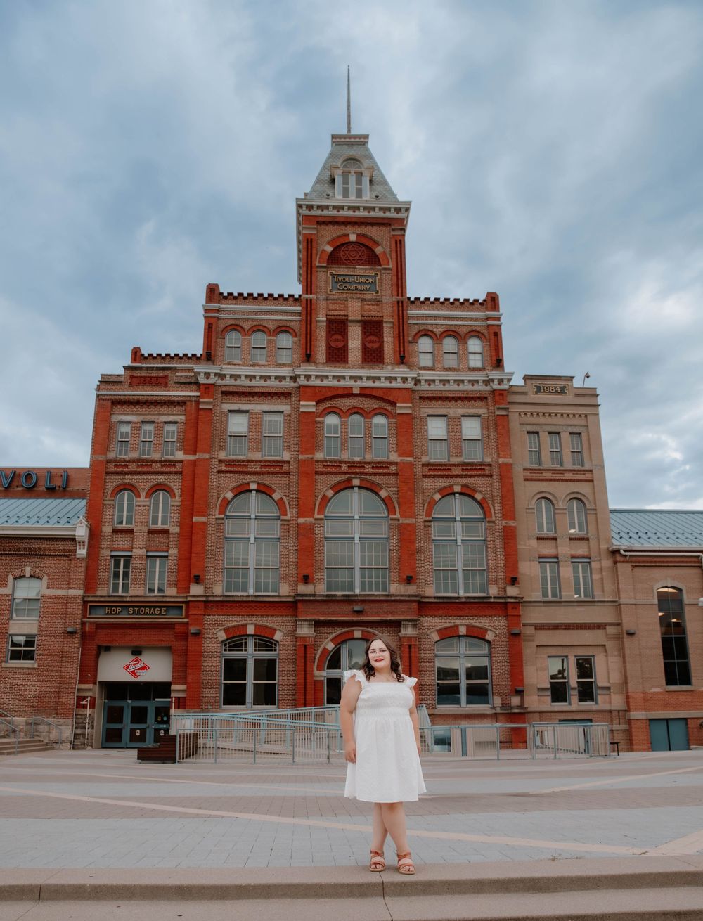 Girl stands and poses for senior photos, cinematic, urban, and portrait photos in Denver, Colorado outside and in nature