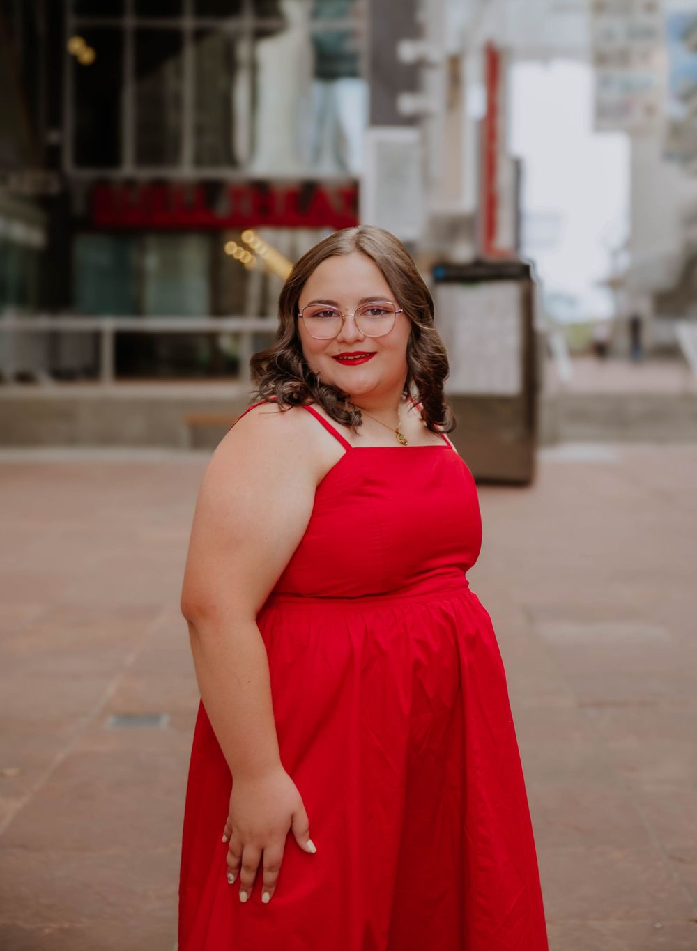 Girl stands and poses for senior photos, cinematic, urban, and portrait photos in Denver, Colorado outside and in nature