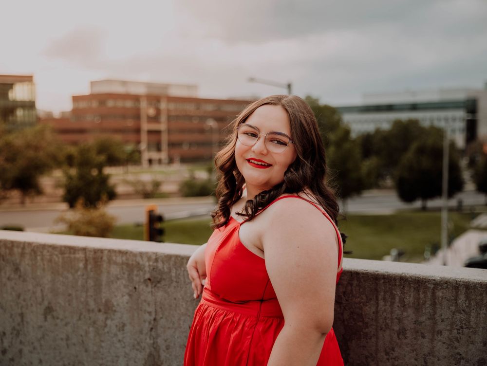 Girl turns, smiles, and poses for senior photos, cinematic, urban, and portrait photos in Denver, Colorado outside and in nature