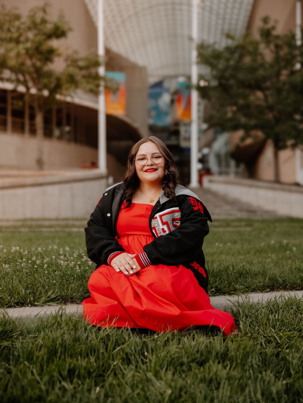 Girl sits, and poses for senior photos, cinematic, urban, and portrait photos in Denver, Colorado outside and in nature