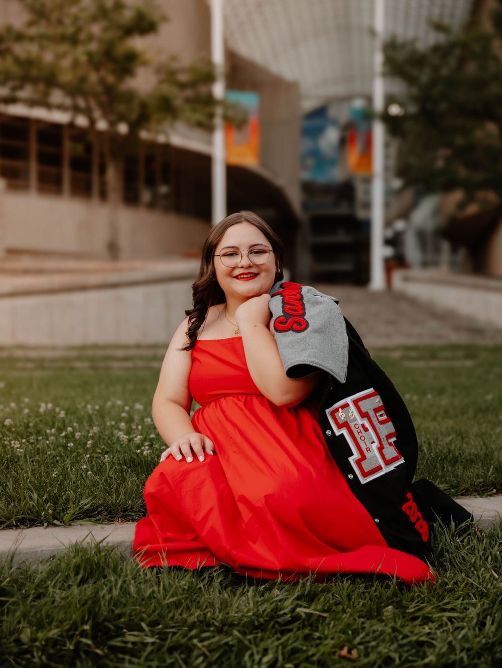 Girl sits, and poses for senior photos, cinematic, urban, and portrait photos in Denver, Colorado outside and in nature