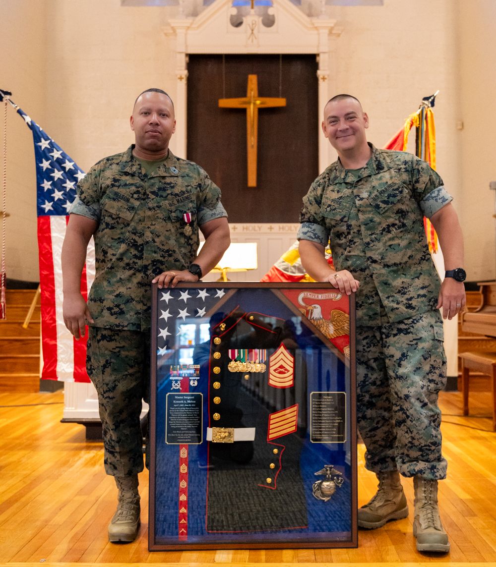 A U.S. Marine Corps Master Sergeant smiling during their retirement ceremony, celebrating 20 years of honorable service.