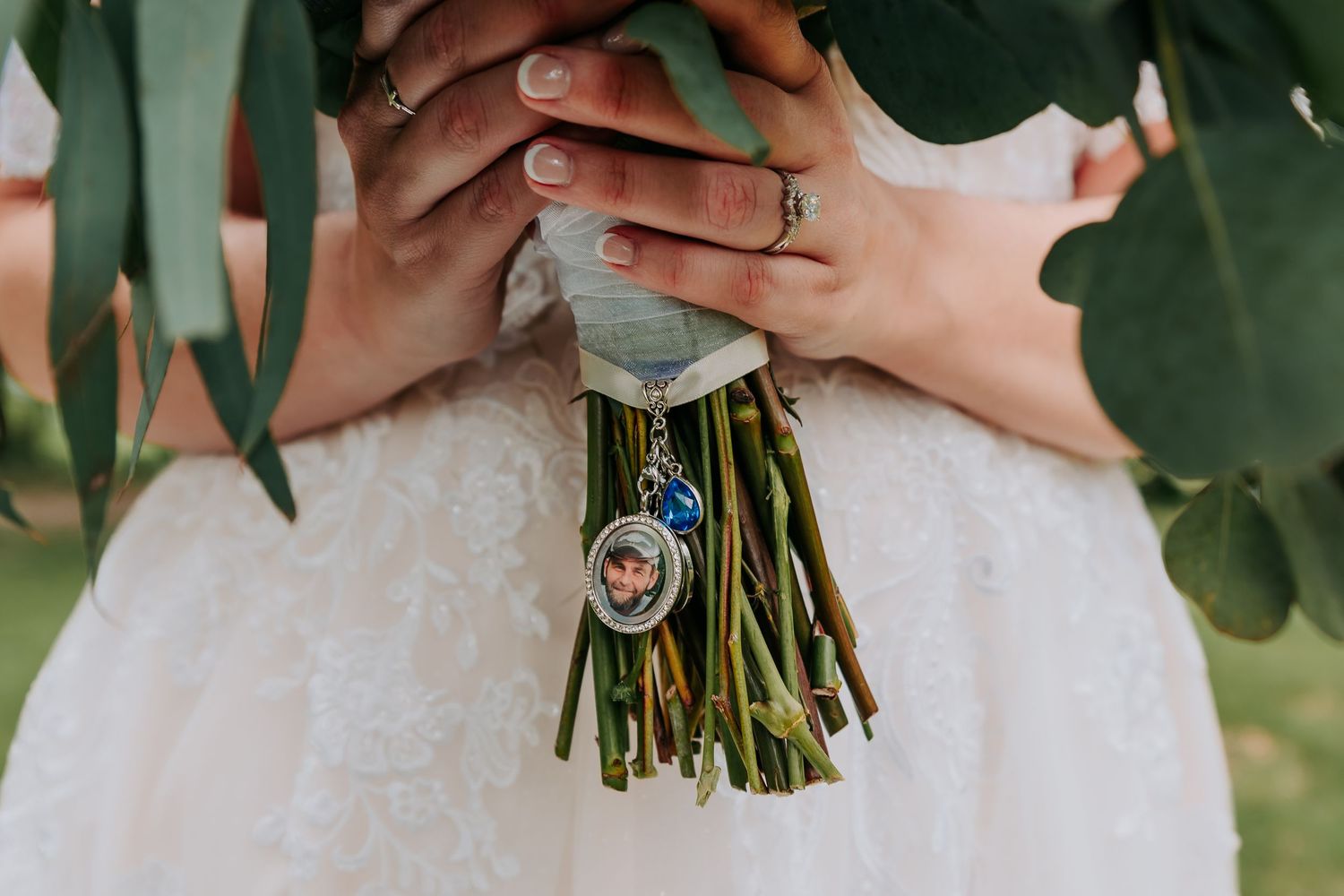 Close-up detail shots of hands holding a bridal bouquet with white flowers and greenery.
